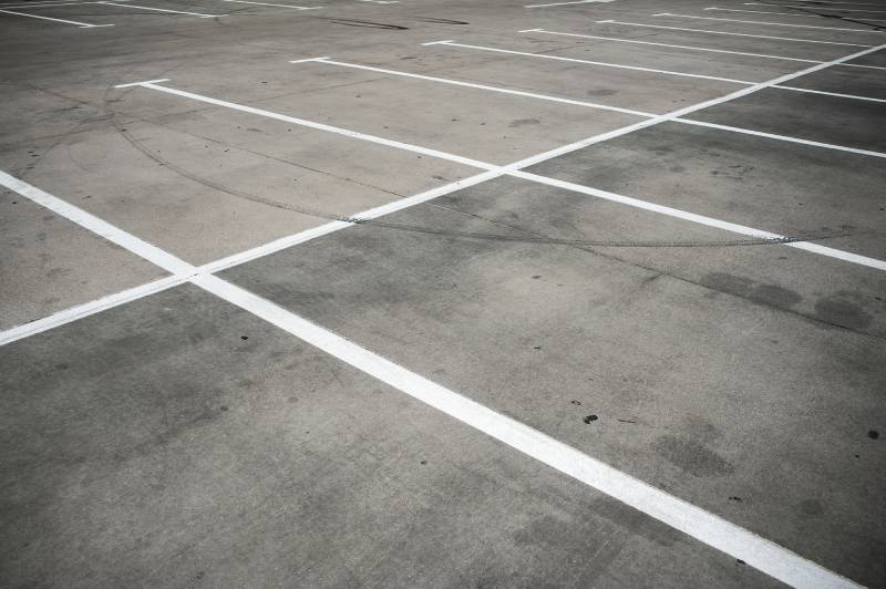 Closeup of a concrete parking lot.